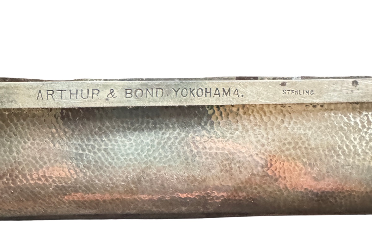 Photograph of an American-style sterling silver wordmark stamped with maker's name and the word STERLING
