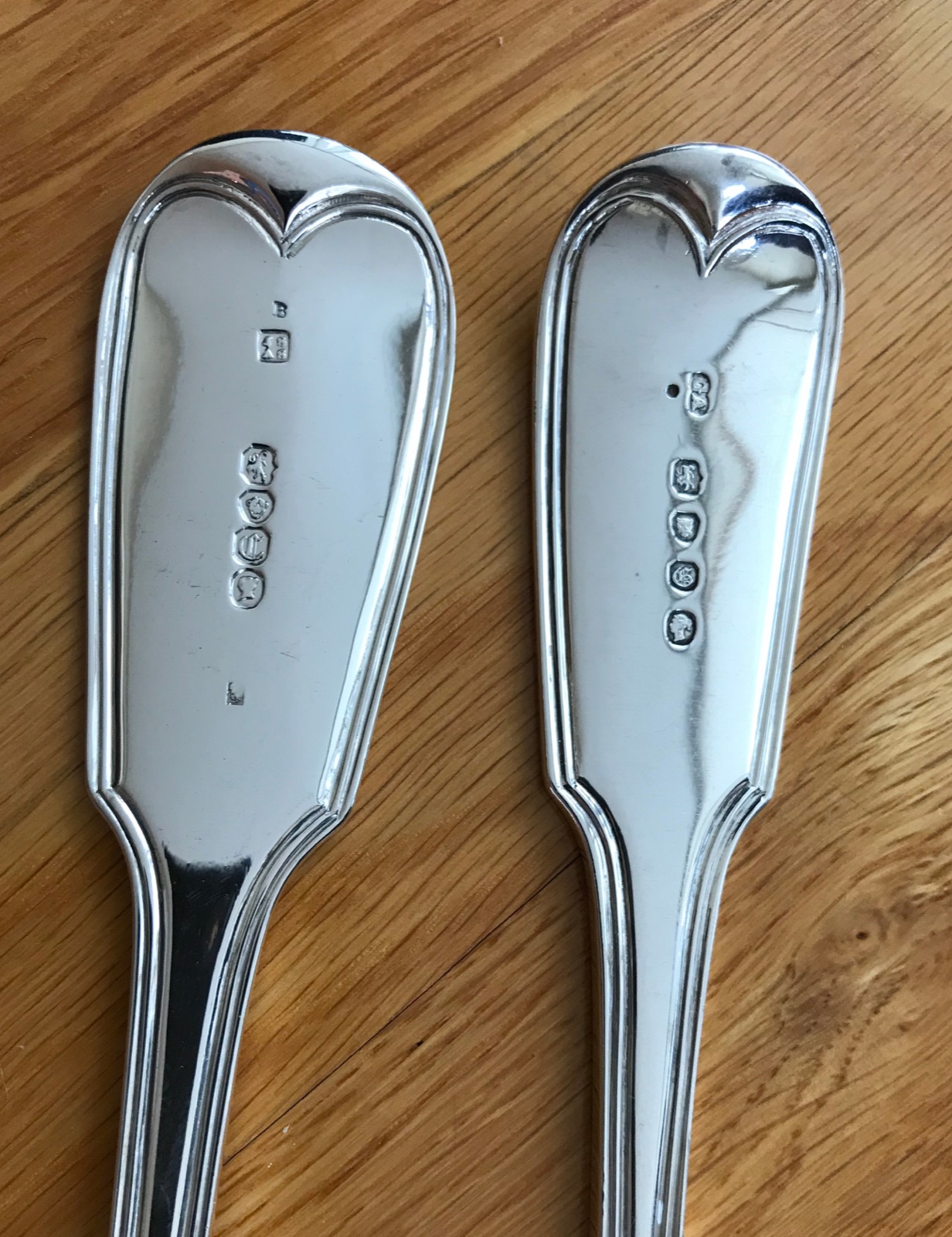 Two complete English silver hallmark sets showing lion passant, leopard's head, date letters, maker's initials, and Victorian duty marks alongside tally marks